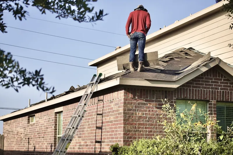 Professional roofer working on a residential roof in Benharts